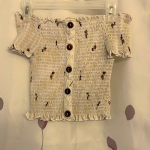 Off the shoulder cropped top with flowers.